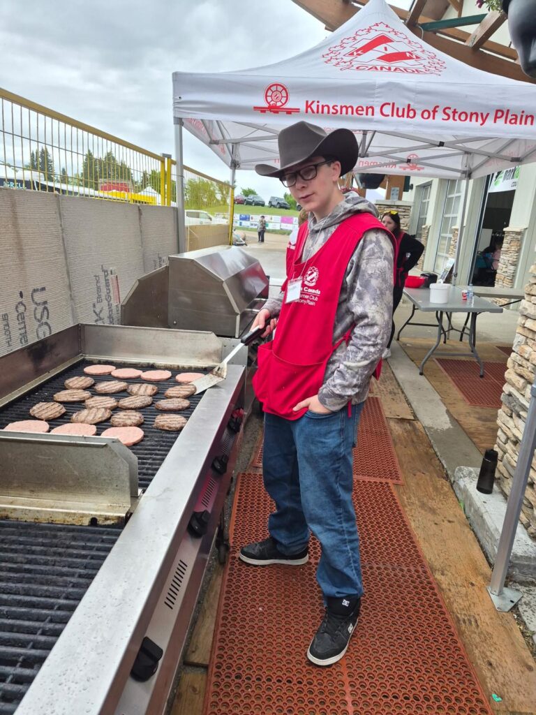 Youth standing by BBQ