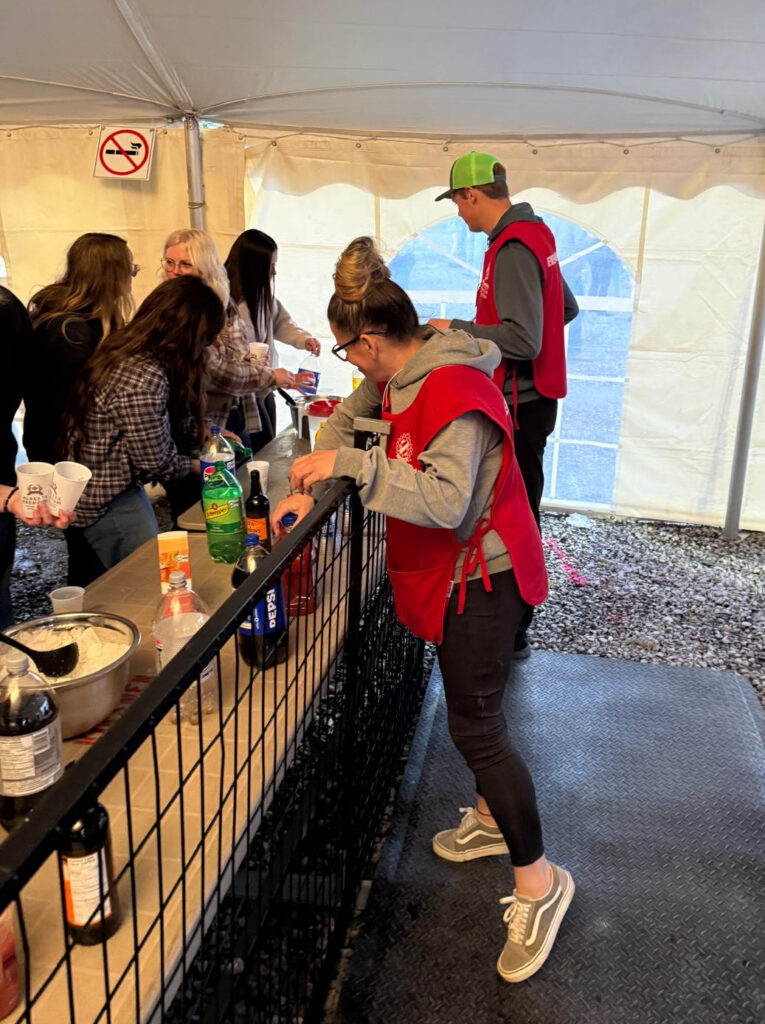 Two volunteers working behind a bar