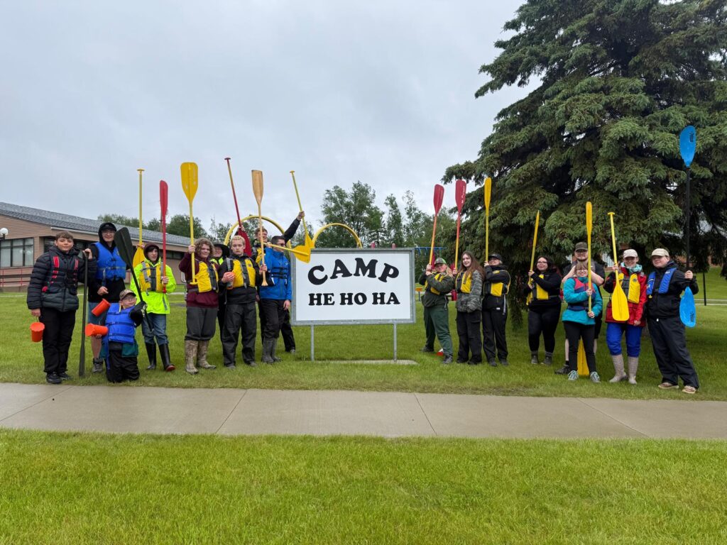 A group of people cheering by a sign that says 