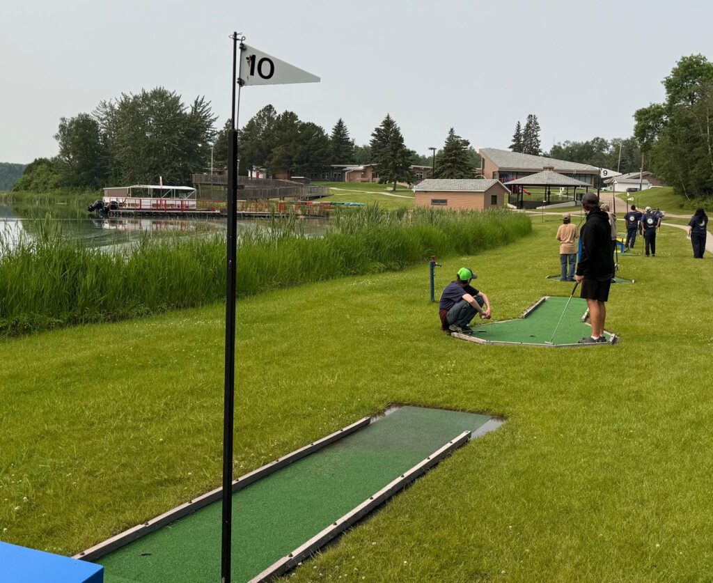A group of people on a mini golf course